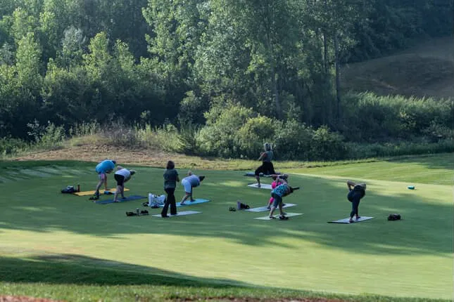 Group holding a standing balance on a fairway